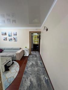 a living room with a couch and a table at 3х комнатная квартира in Shymkent