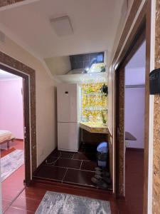 a refrigerator in a room with a door open at 3х комнатная квартира in Shymkent