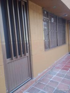 an entrance to a building with a door and windows at El Recuerdo de Paipa, Boyacá, Colombia in El Manzano