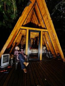 a person sitting in the front of a tiny house at Refugios de Altaguita in Suesca