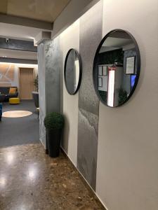 a hallway with a round mirror on a wall at Hotel Sokak in Sarajevo