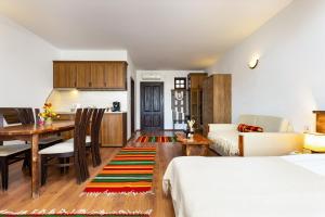 a living room with a kitchen and a dining room at Vacation Apartment in Starosel POOL & SPA in Starosel