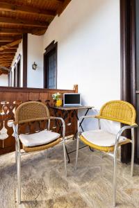 two chairs sitting next to a desk with a computer at Vacation Apartment in Starosel POOL & SPA in Starosel