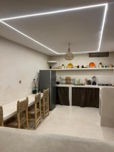 a kitchen with a table and chairs in a room at Tamonda in Tamraght Ouzdar