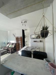 ein Wohnzimmer mit einem Tisch und einem Sofa in der Unterkunft Grand studio au Grau-du-Roi proche Seaquarium et plage in Le Grau-du-Roi