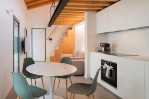 a kitchen and dining room with a table and chairs at Sarius Relais in Seriate +2 photos