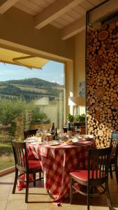 a table with a red and white checkered table cloth at Borgo Conde Wine Resort in Forlì