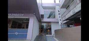a building with a sign that says pharmacy on it at AZURE stay happy in Pudunagaram