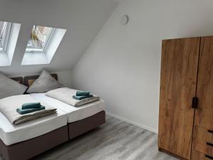 a bedroom with a bed and a wooden cabinet at Ferienhaus Moritz in Ippesheim
