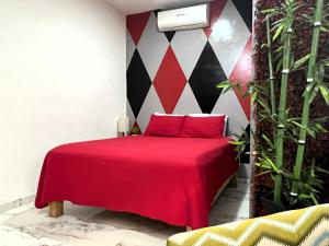 een slaapkamer met een rood bed met rode kussens bij La Puerta Blanca #5 in Puerto Vallarta
