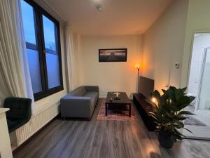 a living room with a couch and a table at 86 1 City Appartement in Enschede