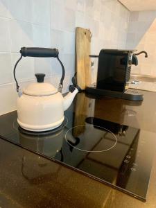 a tea kettle sitting on top of a kitchen counter at La Bastide in Heiloo +20 photos