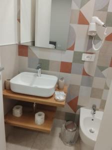 a bathroom with a sink and a toilet at Regia Dimora in Eboli