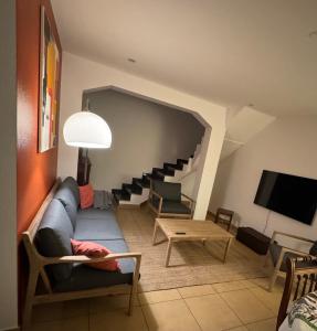 a living room with a couch and a table at Résidence du Loeb in Eschau