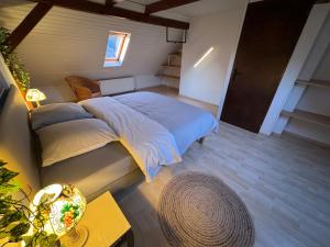 a bedroom with a large bed and a table at Résidence du Loeb in Eschau