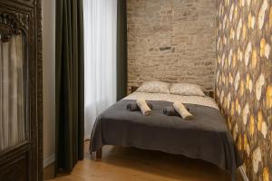 a bedroom with a bed with two pillows on it at Old Town Luxury 2 Bedroom Suite 65 m2 on 3rd floor in Tallinn