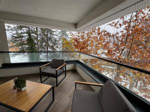 a room with a balcony with a table and chairs at Dinka Apartments Park Lake in Tuzla +36 photos