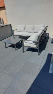 a couch and a coffee table on a patio at Jagersrust aan zee in Blankenberge