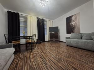 a living room with a couch and a table at Apartament Antracyt in Wałbrzych