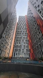 a tall building with many windows in a city at Alton City Loft in Jatingaleh