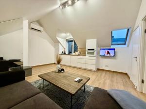 a living room with a couch and a table at Centro apartamentai in Radviliškis
