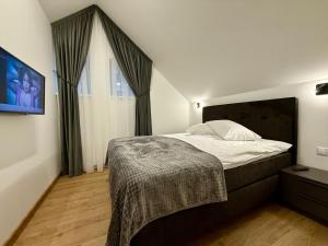 Una cama o camas en una habitación de Centro apartamentai