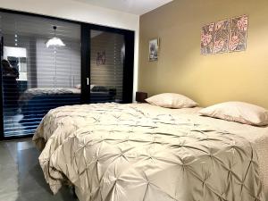 a bedroom with a large bed with two pillows at La Loggia - Appartement Terrasse Esch Belval in Esch-sur-Alzette