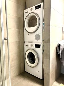 eine Waschmaschine sowie eine Waschmaschine und ein Trockner im Bad in der Unterkunft La Loggia - Appartement Terrasse Esch Belval in Esch-sur-Alzette + 6 Fotos