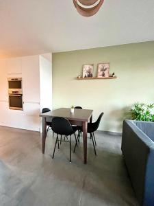 a dining room with a wooden table and chairs at La Loggia - Appartement Terrasse Esch Belval in Esch-sur-Alzette