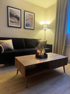 a living room with a couch and a coffee table at Kirkview Cottage in Peterhead