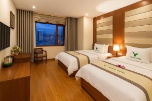 a hotel room with two beds and a window at Moonlight Hotel & Apartment - High Floor, panoramic views of the city and river, Dragon Bridge in Da Nang +10 photos