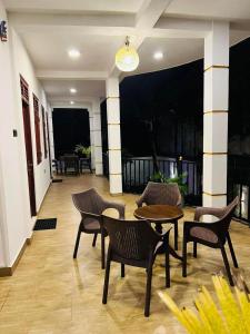 a patio with chairs and a table and a table at Eolie Loft in Colombo