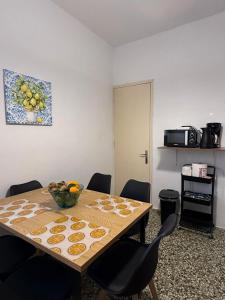 a dining room table with a bowl of fruit on it at Marina Helios Home in Áyios Yeóryios +10 photos