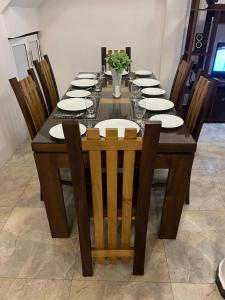a dining room table with chairs and plates on it at Eolie Loft in Colombo