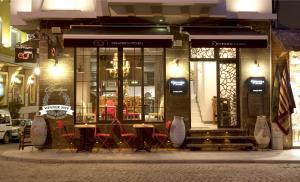 a restaurant with tables and chairs in front of a building at Hypnos Design House in Istanbul