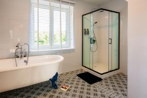 a bathroom with a tub and a glass shower at Villa Basse Cour in Durbuy +43 photos
