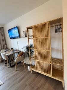 a room with a desk and a bed and a table at LakeCity Apartment in Klagenfurt +9 photos