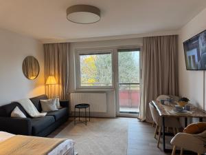 a living room with a couch and a table at LakeCity Apartment in Klagenfurt