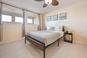 a bedroom with a bed and a ceiling fan at Beach Townhome Steps from Downtown Cocoa Beach in Cocoa Beach
