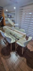 a glass table and chairs in a room at Casa mirador de volcanes, 6 personas in Llanquihue