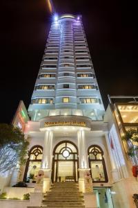 a tall building with stairs in front of it at Moonlight Hotel & Apartment - High Floor, panoramic views of the city and river, Dragon Bridge in Da Nang