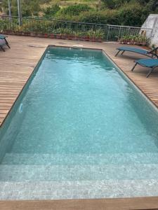 a large swimming pool with clear blue water at Paradise House Calheta in Calheta