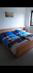 a bedroom with a bed with an american flag blanket at Zimmer mit Stall in Geestland