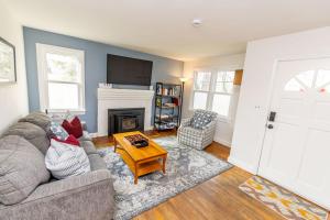 a living room with a couch and a fireplace at Pet Friendly Retreat Near Downtown Annapolis in Annapolis