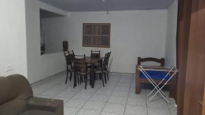 a dining room with a table and chairs at Casa em Ubatuba beach two in Ubatuba +10 photos