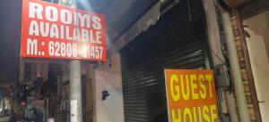 a store with a red sign in front of a garage at A One Guest House in Jalandhar