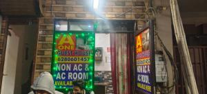 a sign for a one guest house and an ak room at A One Guest House in Jalandhar