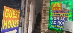 a guest house sign on the side of a building at A One Guest House in Jalandhar +1 photo
