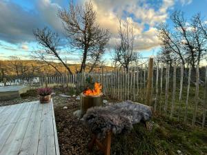 a garden with a wooden deck and a fence at Modern Cabin By The Ski Trails At Fagerhøy in Sør-Fron