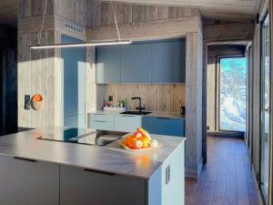 a kitchen with a bowl of fruit on a counter at Modern Cabin By The Ski Trails At Fagerhøy in Sør-Fron